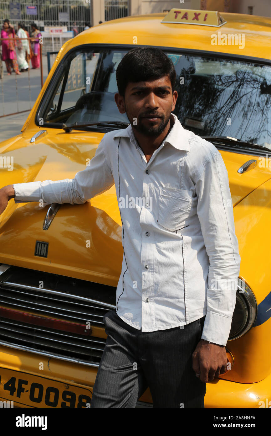 Indian taxi driver posing in front of his cab in Kolkata. The car is Hindustan Ambassador, manufactured since 1958. Stock Photo