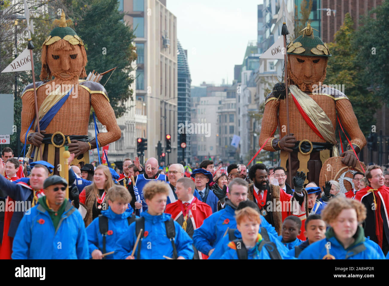 City of London, London, UK, 09th November 2019. Two large Gog & Magog figures with the Guild of Freemen proceed down the road at St Paul's. The annual Lord Mayor's Show, a parade through the City of London that is 804 years old and this year features over 6000 participants, sees marching bands, military detachments, carriages, dance troupes, inflatables and many others make their way from Mansion House, via St Paul's to the Royal Courts of Justice. Credit: Imageplotter/Alamy Live News Stock Photo