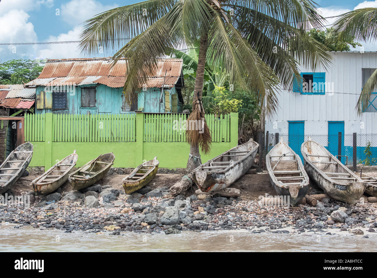 Sao Tome, dugouts on the beach in fishermen's village, typical houses Stock Photo