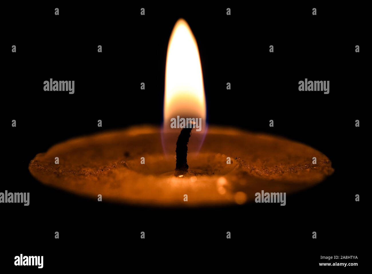 Soft candle light over black blurred background, inspirational peace mood Stock Photo