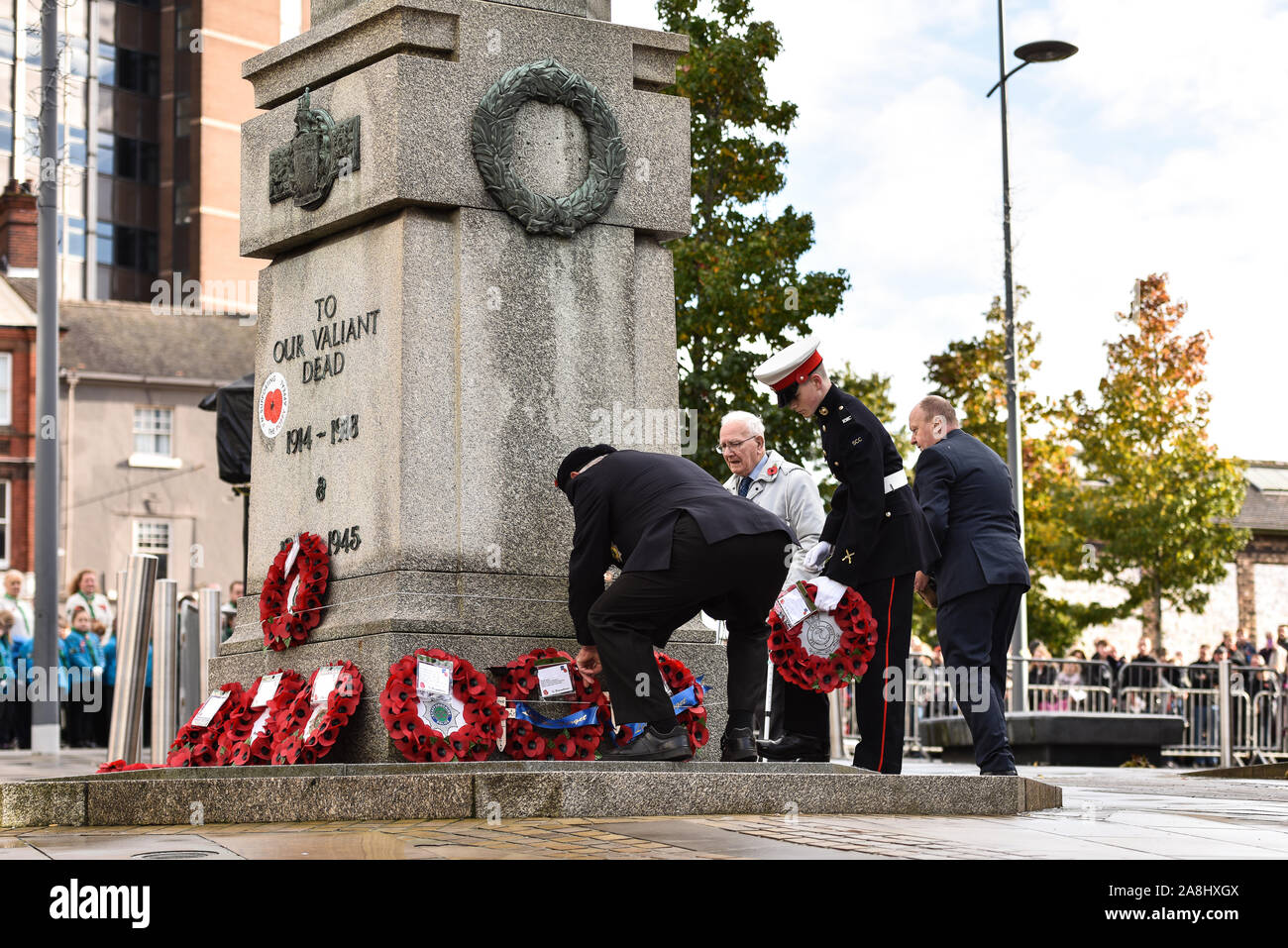 Veterans and civilians lay reefs and notes of condolence to the fallen at the Remembrance Day, armistice day parade in the city centre of Hanley, Stock Photo