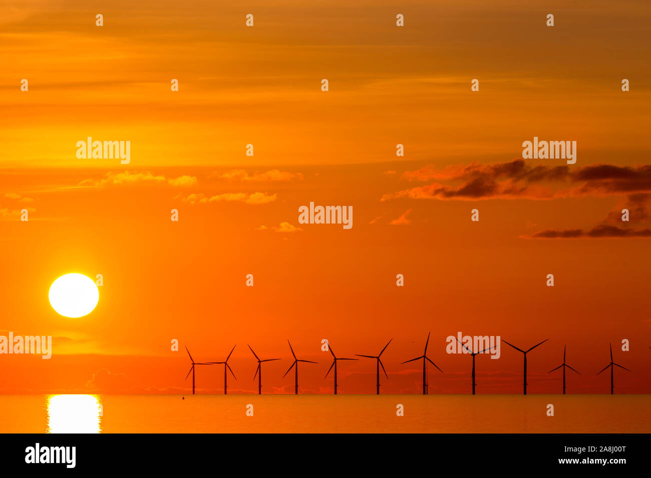 Sunset over the Gwynt y Mor windfarm from Rhyl on the North Wales coast Stock Photo