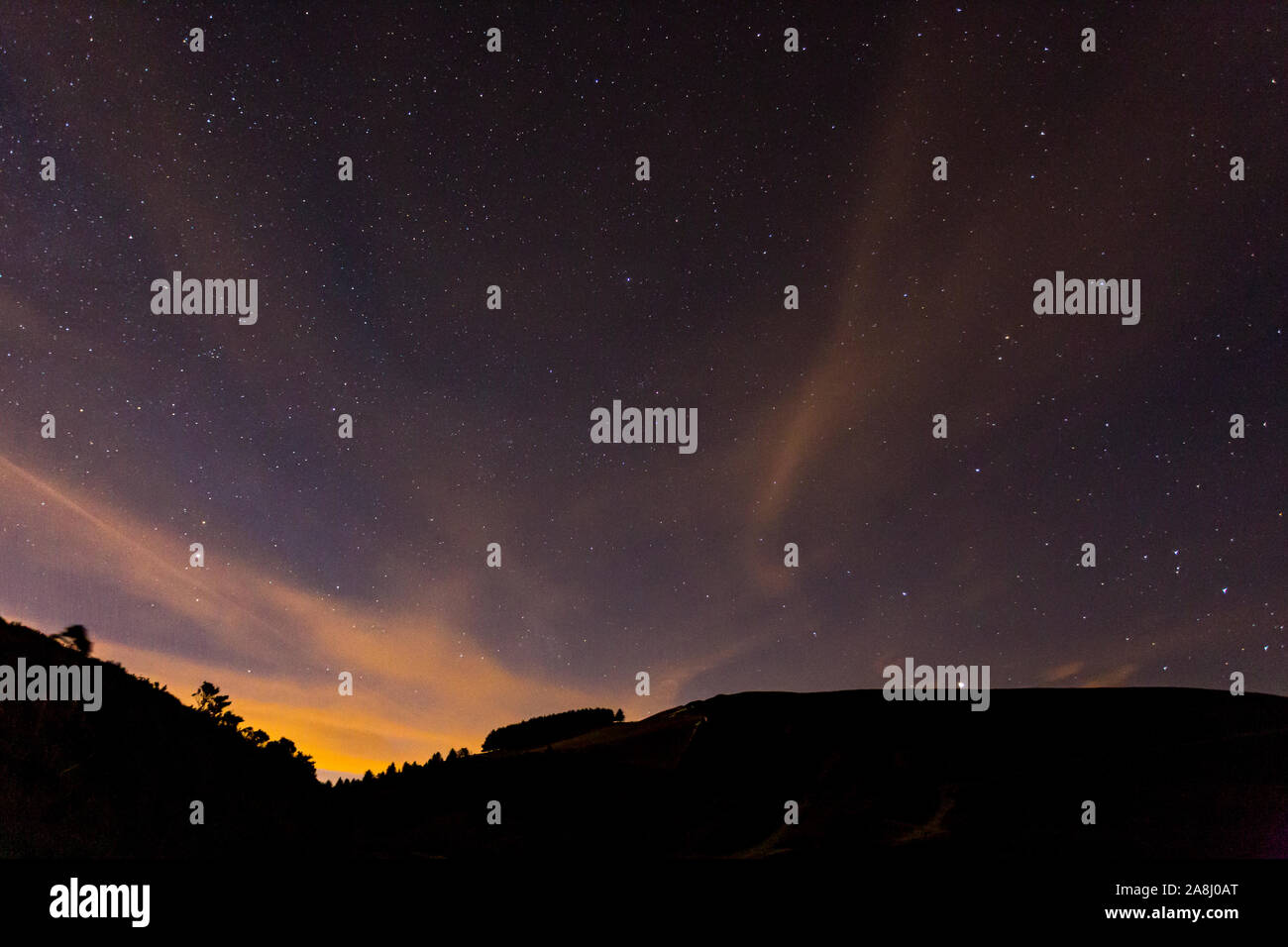 Stars and clouds over the Clwydian Range at night, North Wales Stock Photo