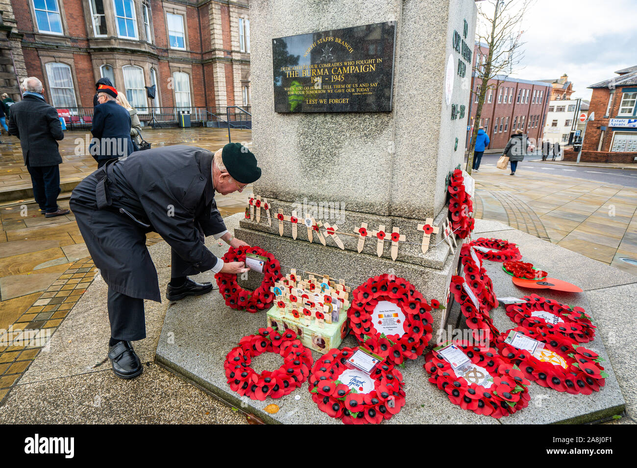 Veterans and civilians lay reefs and notes of condolence to the fallen