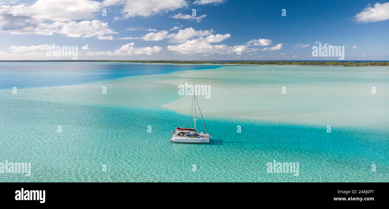 Sailing with catamaran in Tuamotu Archipelago french Polynesia - Aerial view of the lagoon by drone Stock Photo