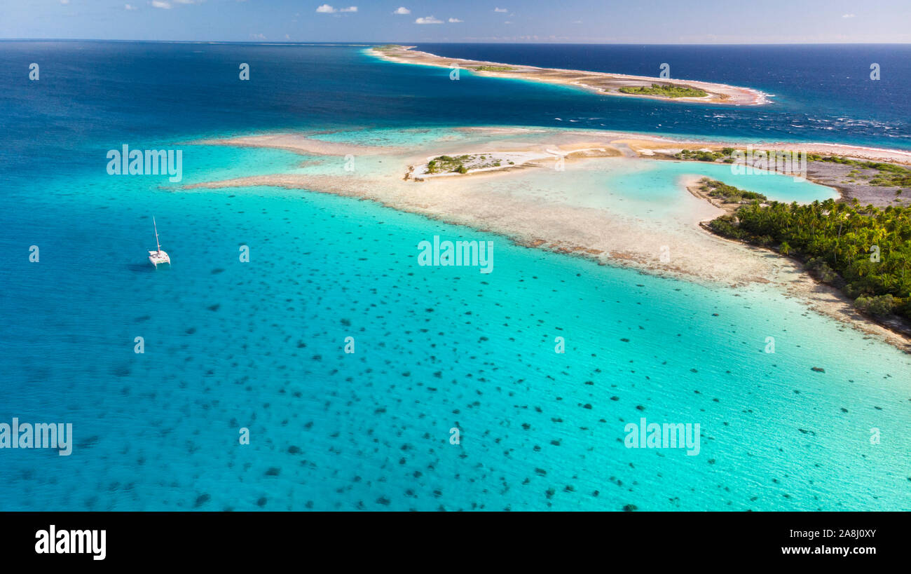 Sailing with catamaran in Tuamotu Archipelago french Polynesia - Aerial view of the lagoon by drone Stock Photo