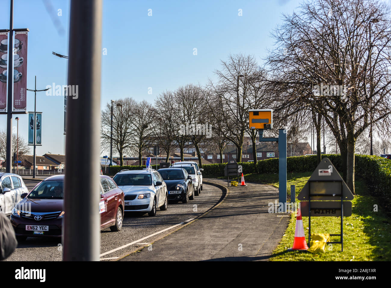 Cars travel past a speed camera in Stoke on Trent, slowing down as they pass the camera, safe driving Stock Photo