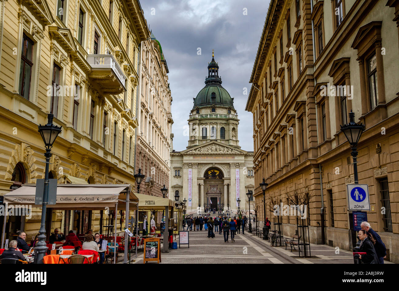 People walking at Zrinyi Street, one of the famous streets in Budapest, St. Stephen's Basilica can be seen at the background. Stock Photo