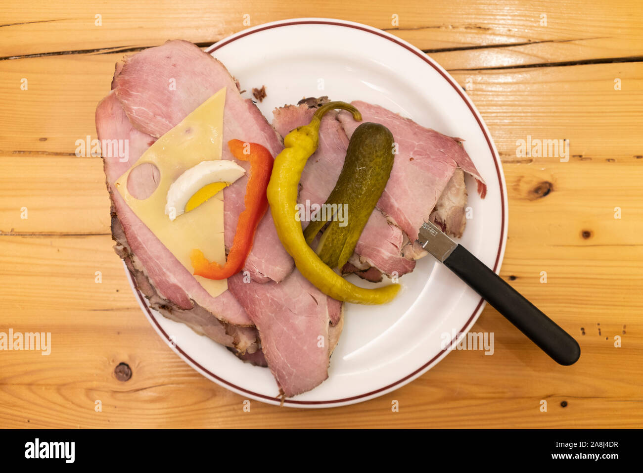 A Belegtes Brot (bread with ham and cheese) on a plate served at a Heuriger in Lower Austria. The food is simple and a typical dish of the area Stock Photo