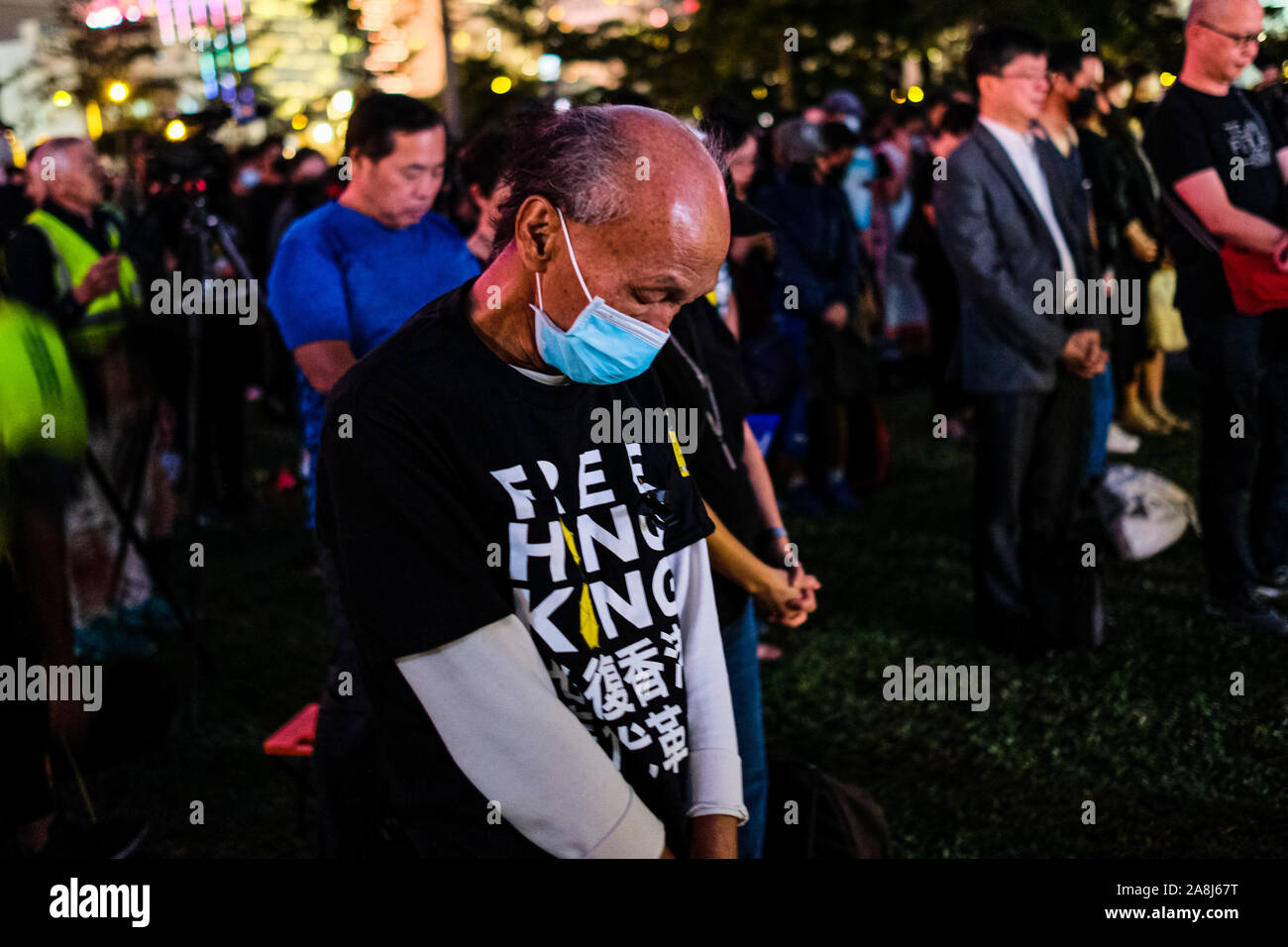 Hong Kong, China. 9th Nov, 2019. Tens of thousands of Hong Kongers pray during a memorial rally at Tamar Park in Hong Kong to mourn the death of a 22 years old university student Alex Chow Tsz Lok, who died from a serious brain injury during a fall on November 4th as police skirmished with demonstrators last weekend. He was left in critical condition and died after suffering a cardiac arrest on Friday. Credit: Keith Tsuji/ZUMA Wire/Alamy Live News Stock Photo