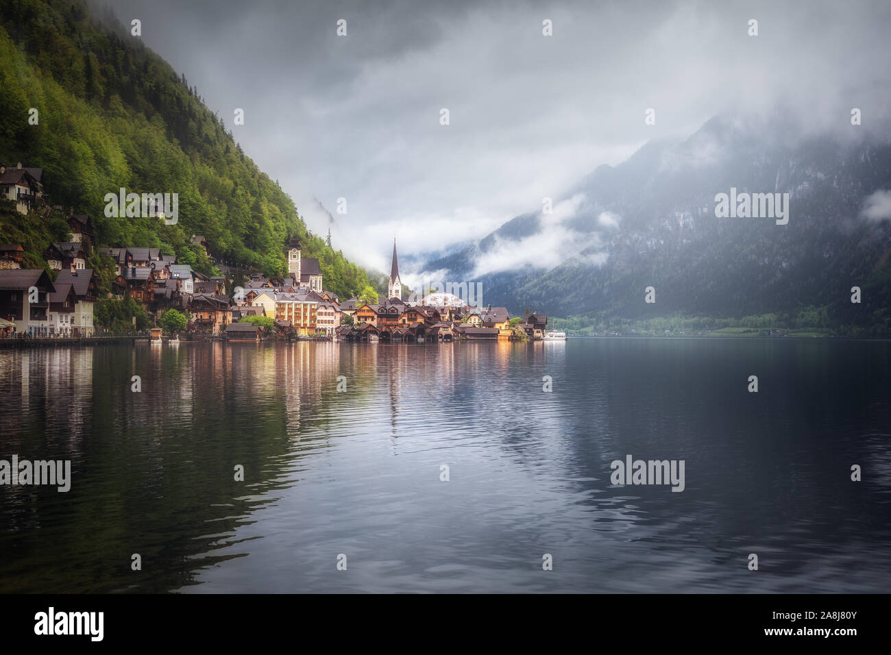 Cloudy day in Hallstatt. Reflection on the lake. Beautiful village in Austria. Stock Photo