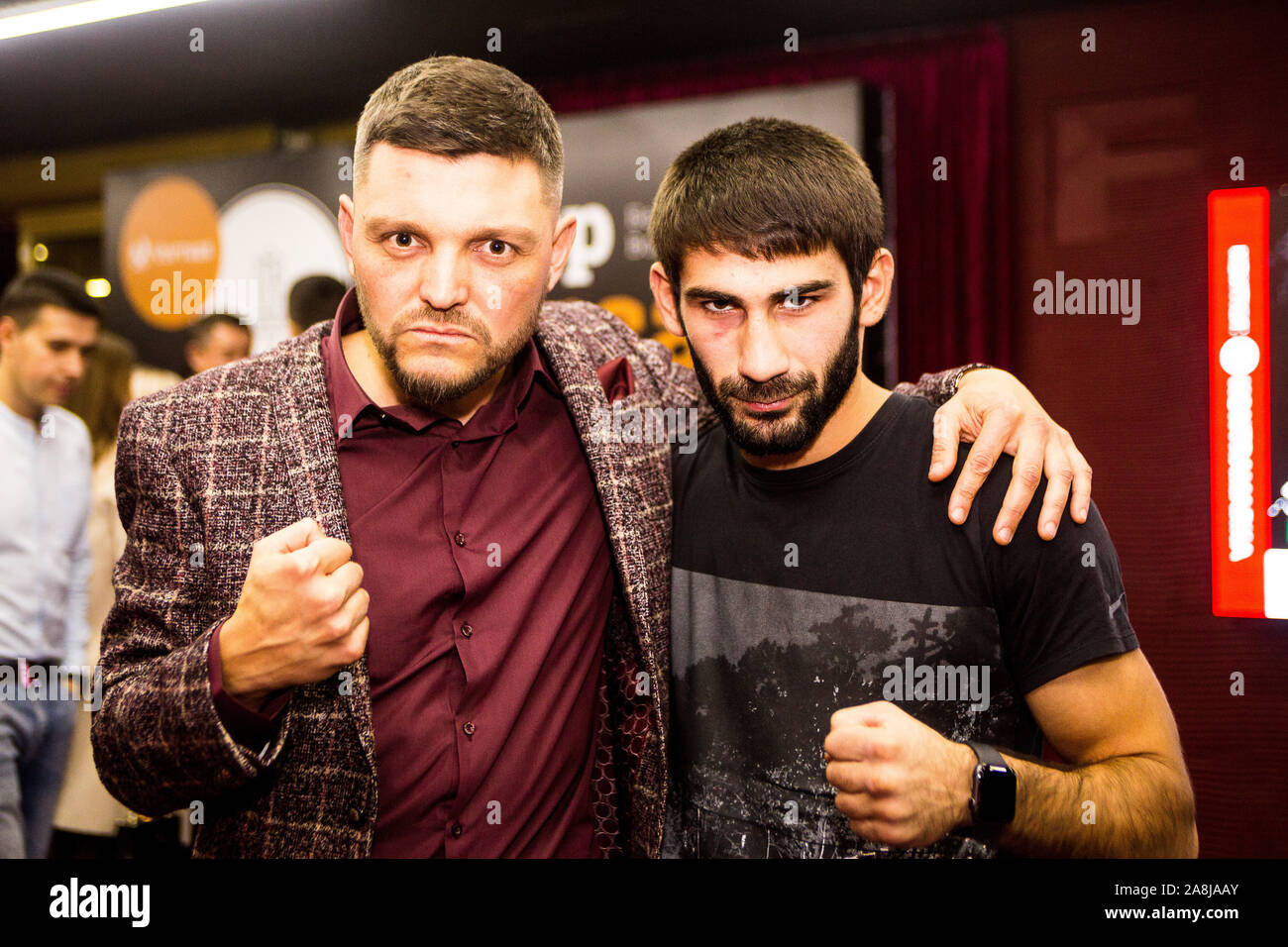 Two friends professional ring announcer and boxer hug and joke at White Collars amature boxing ring card 1 Nov 2019 in Kiev Freedom Hall after fights. Stock Photo
