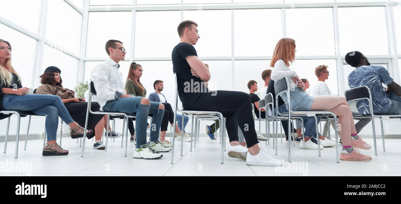 group of young people sitting in a bright conference room Stock Photo ...