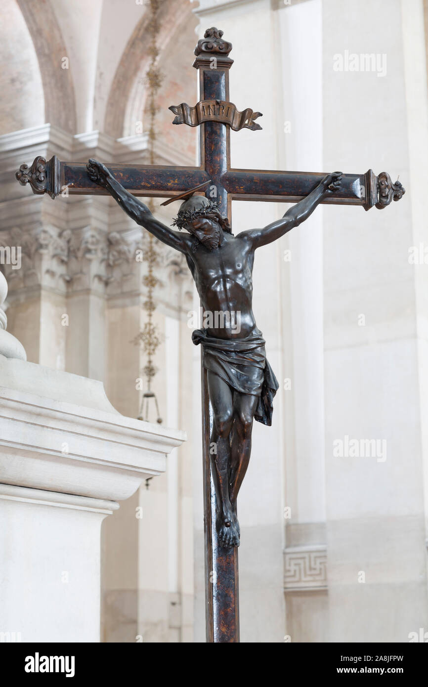 Statue of Jesus Christ on a cross inside a church, depicting the crucifixion Stock Photo