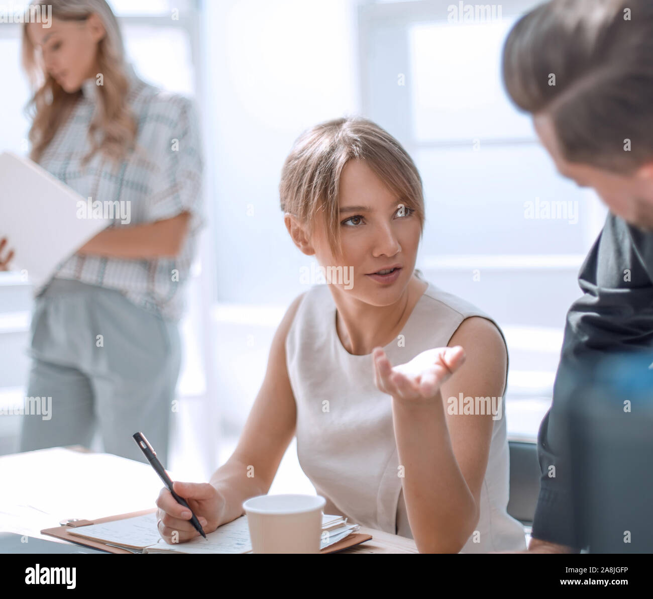 young business woman sitting at office Desk Stock Photo - Alamy