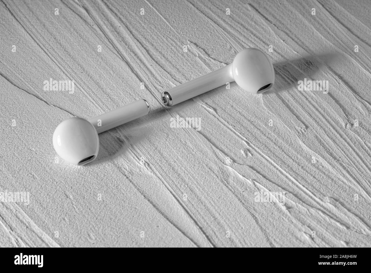 isolated earphones on a texture background Stock Photo
