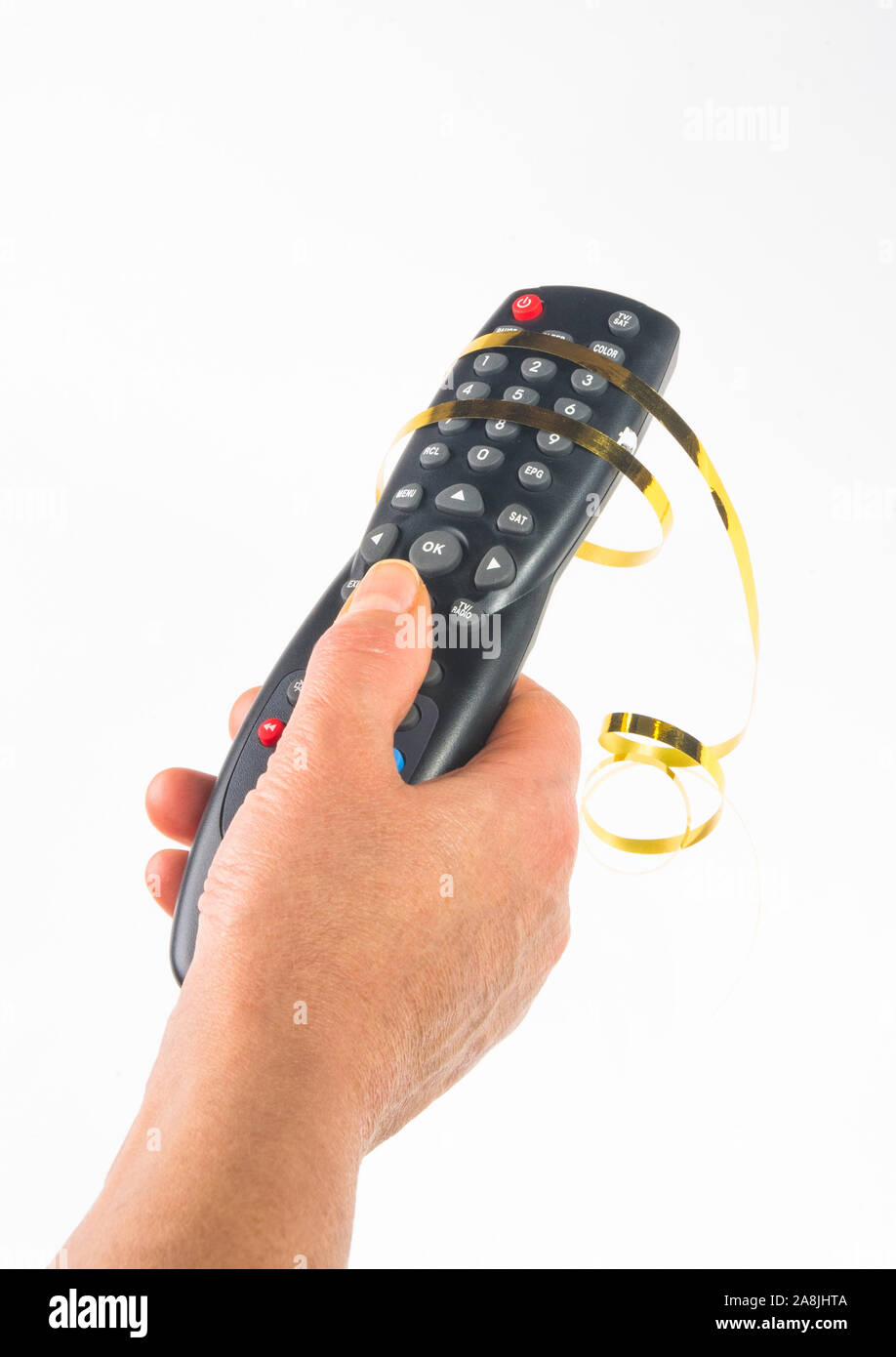 hand holding a remote control in a festive gold ribbon on white