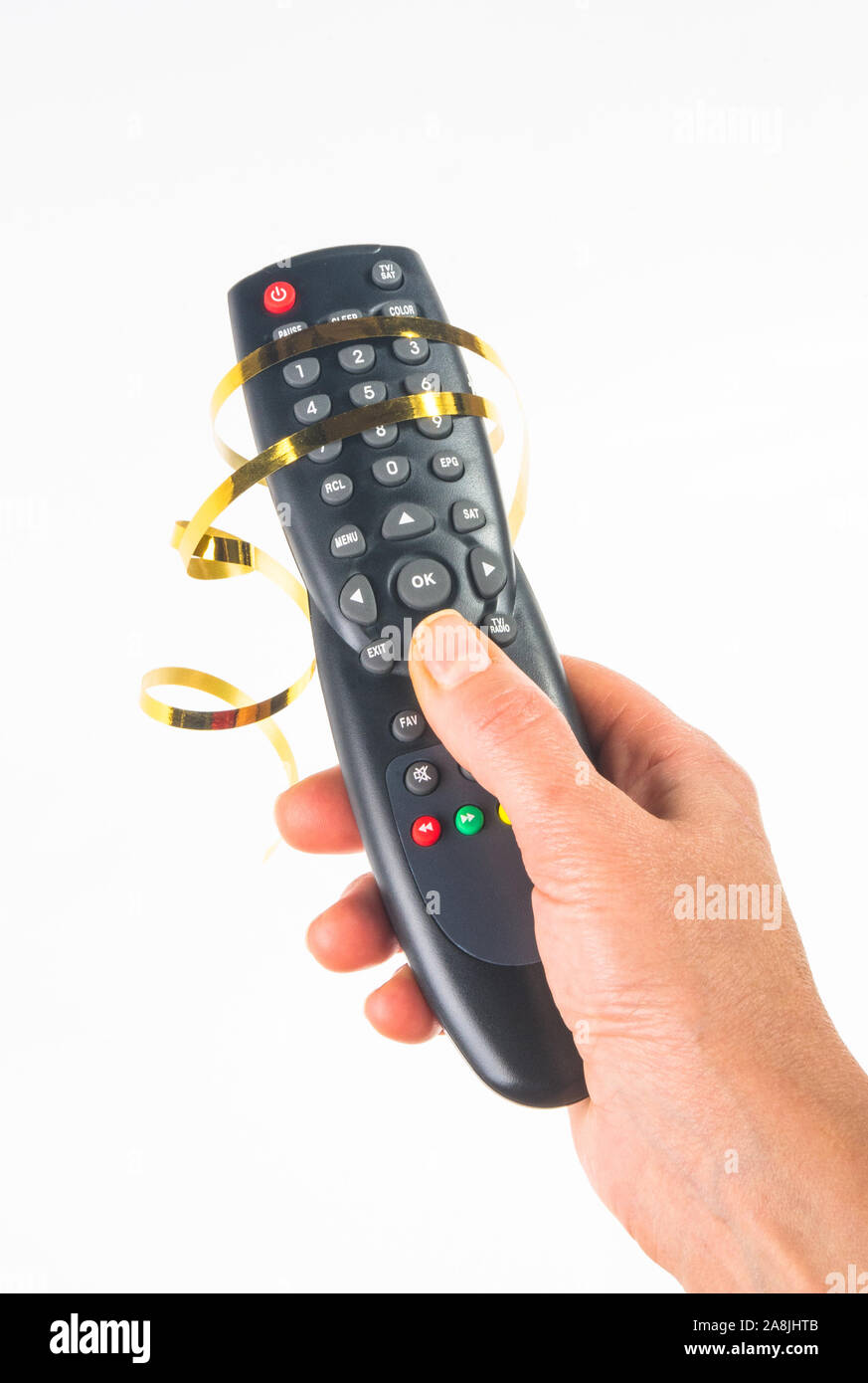 hand holding a remote control in a festive gold ribbon on white