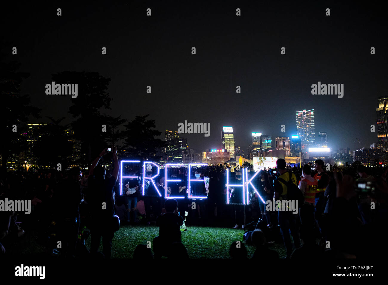 A Free HK sign during the rally.Memorial rally at Tamar Park in Hong Kong to mourn the death of a 22 years old university student, Alex Chow Tsz Lok who died from a serious brain injury during a fall on November 4th as police skirmished with demonstrators last weekend. He was left in critical condition and died after suffering a cardiac arrest. Stock Photo