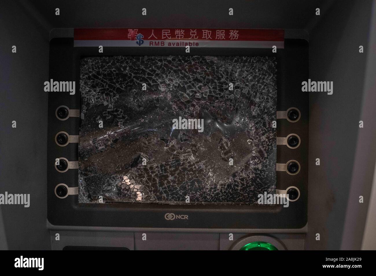 ATM with broken screen at Tseung Kwan O station during the demonstrations.Hong Kong mourns death of student Chow Tsz-lok, a 22 years old University student who died from cardiac arrest in the morning of Friday, 8th of November. Chow Tsz-lok fell from a car park amid chaotic confrontations between Hong Kong riot police and protesters, suffering a severe head injury. Thousands took the streets to mark his passing on. Candlelight vigils were held at the car parking where the incident took place. Stock Photo