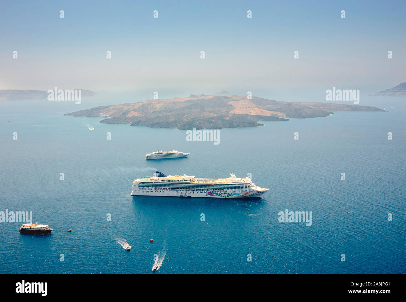 Fira, Santorini/Greece-20JULY2019: Areal view of Norwegian pearl cruise ship in Europe, Greece island of Santorini harbor in summer. Volcanic island Stock Photo