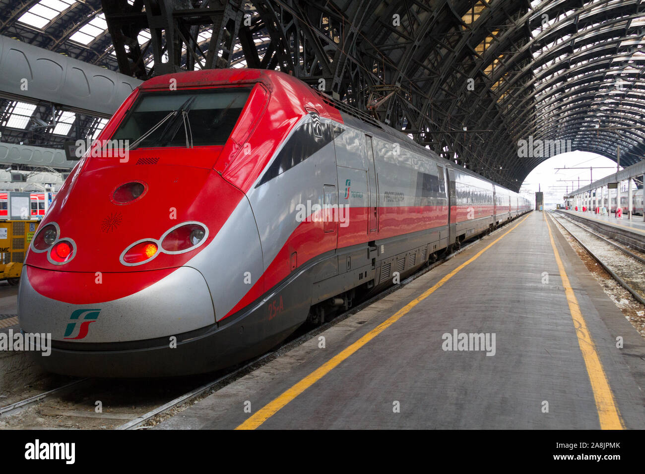 'Frecciarossa', a high-speed Italian train, poised at the Milan Central Station, a major railway hub in Northern Italy. Stock Photo