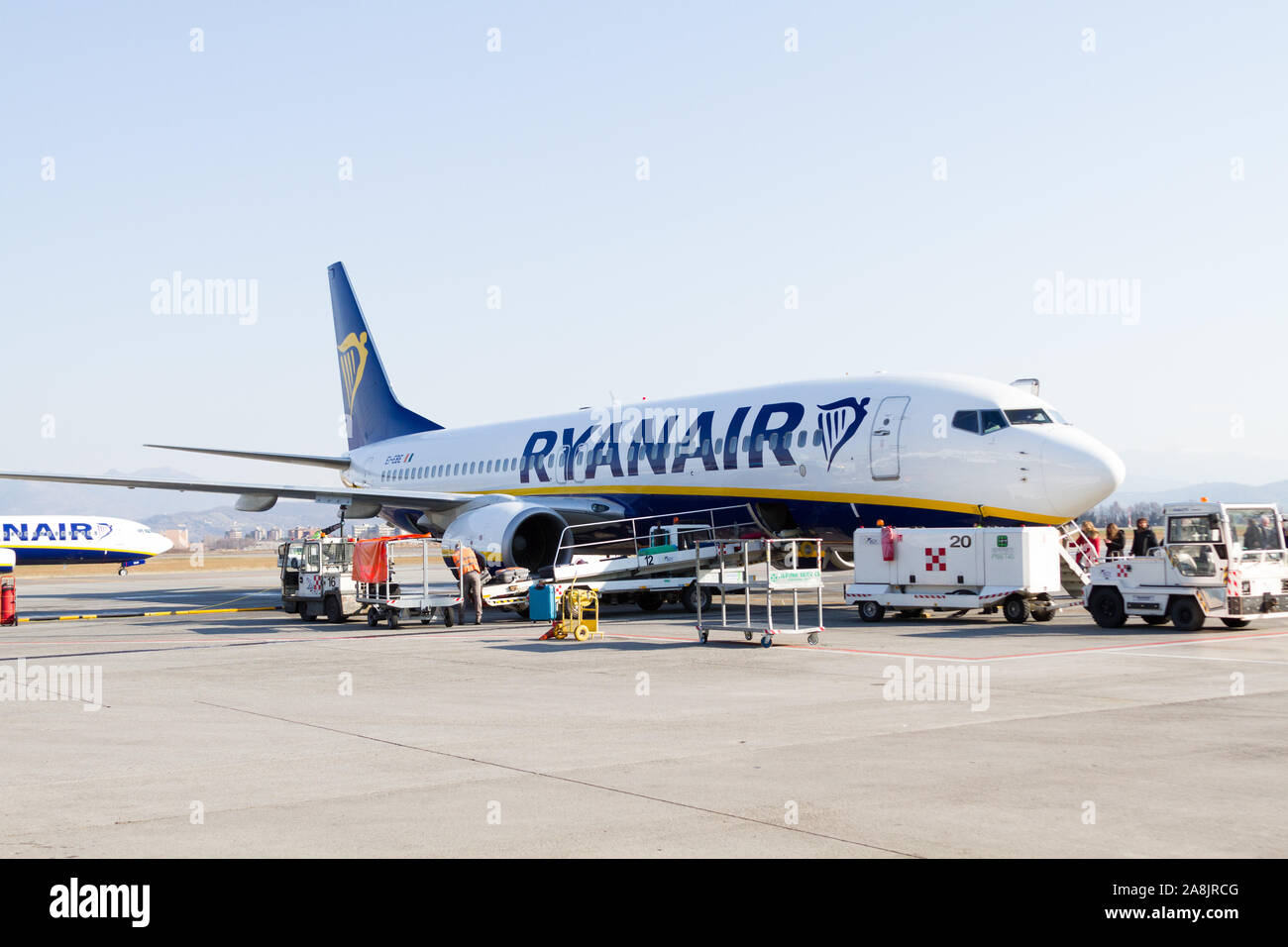 A Ryanair Boeing 737-800 aircraft parked at the Milano Bergamo airport. People are boarding the plane. Stock Photo