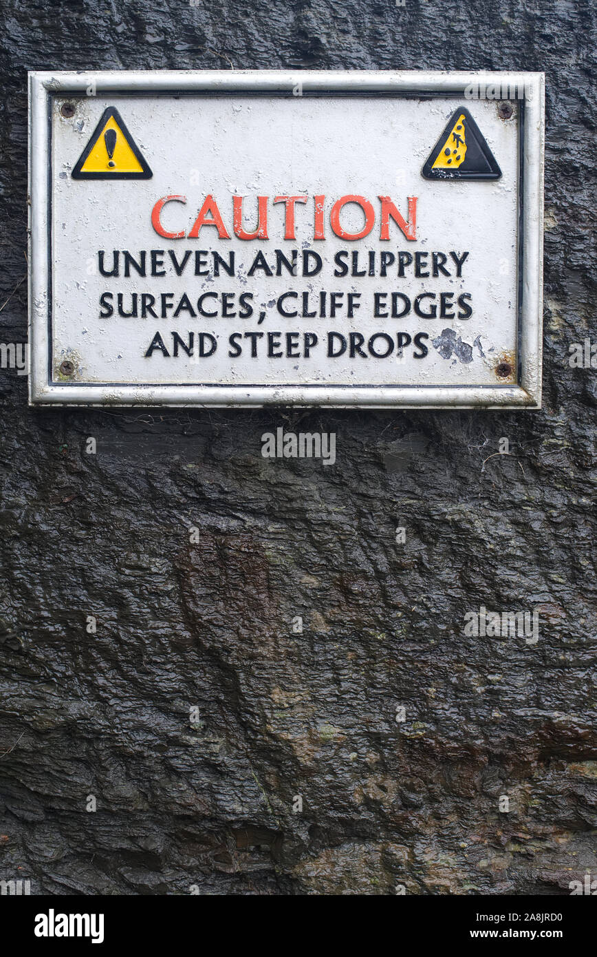 CAUTION uneven and slippery, cliff edges and steep drops surface sign