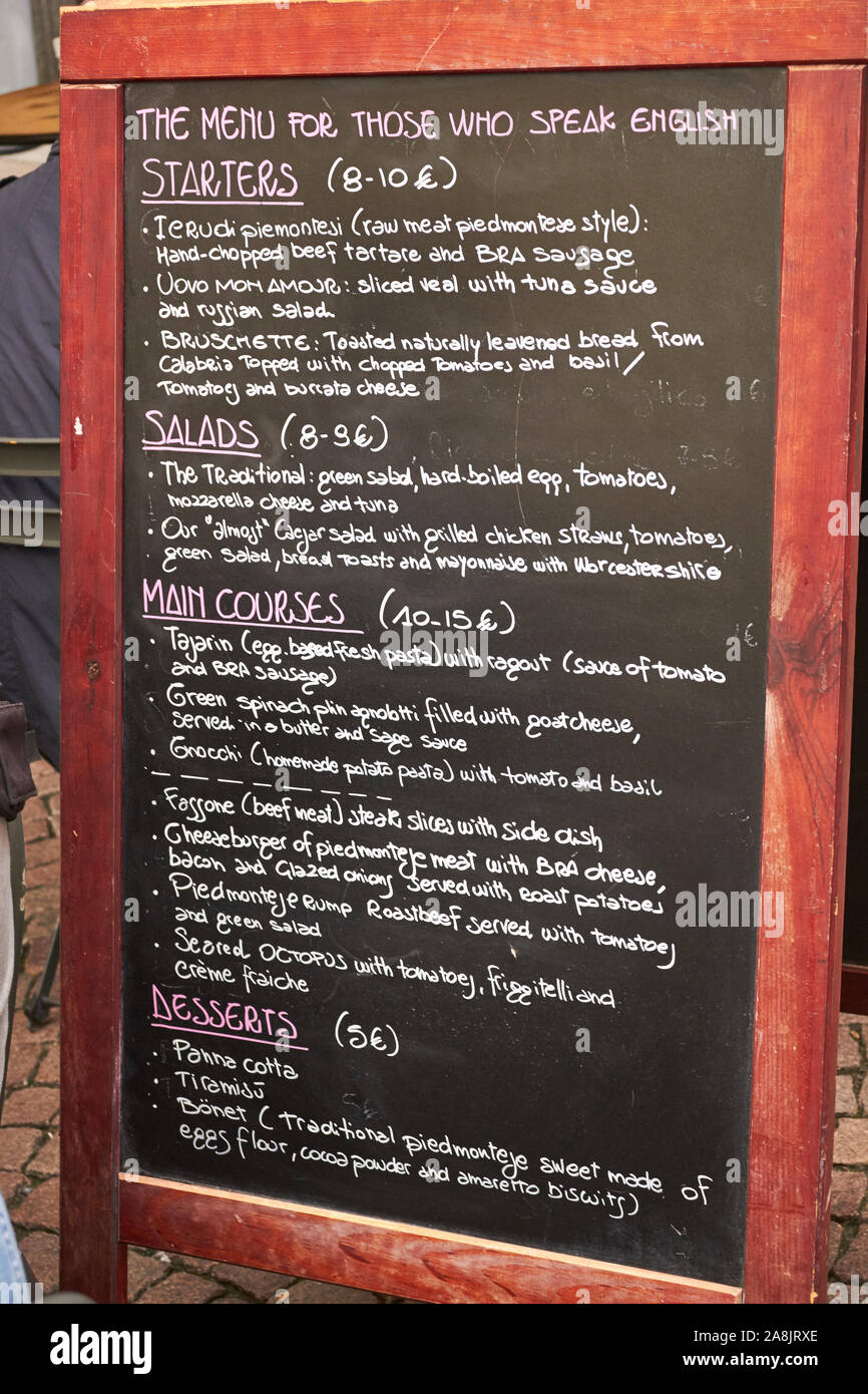 An English Language menu at a restaurant in Bra, Piemone, Italy. It features both Italian regional classics and cheeseburgers too. Stock Photo