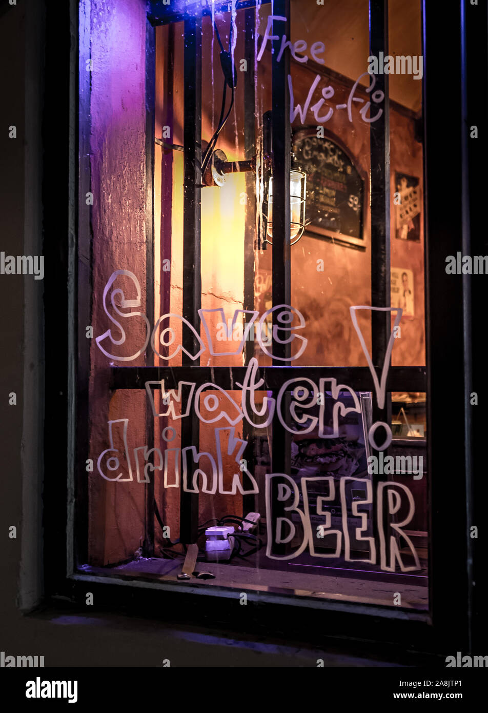 Illuminated Window Of A Bar In The Night Stock Photo