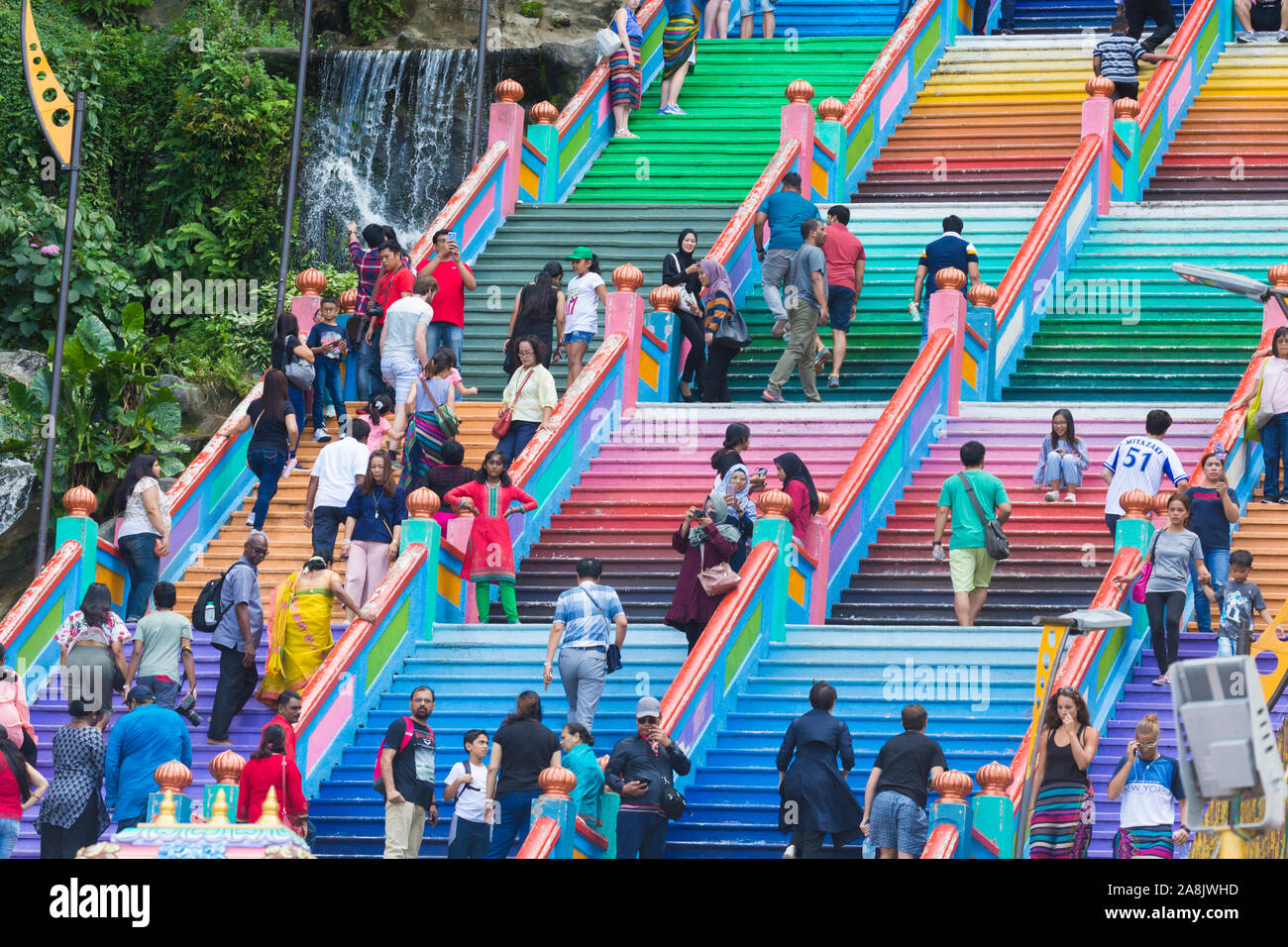 KUALA LUMPUR / MALAYSIA - May 12, 2019: Tourists ascend the colorful ...