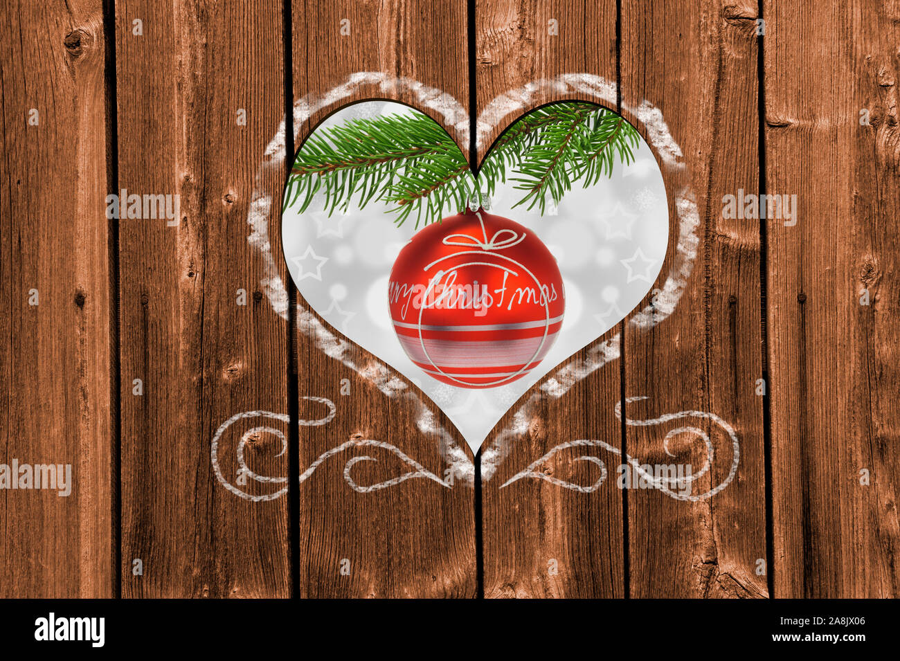 Looking through a carved heart in a wooden wall to christmas decoration Stock Photo
