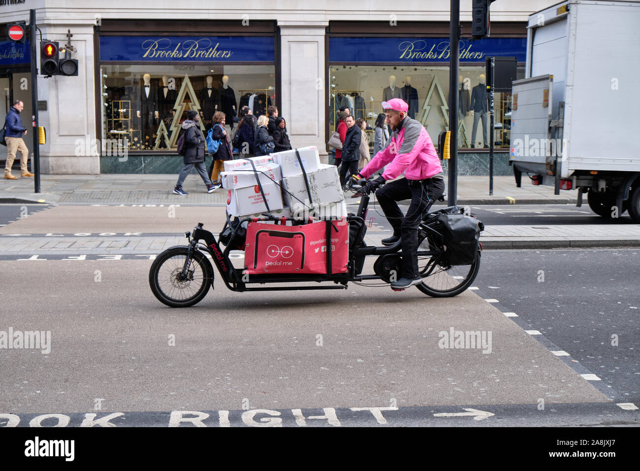 Pedal Me cargo bike delivery service, loaded with multiple boxes riding on Regent Street, London, UK. Stock Photo