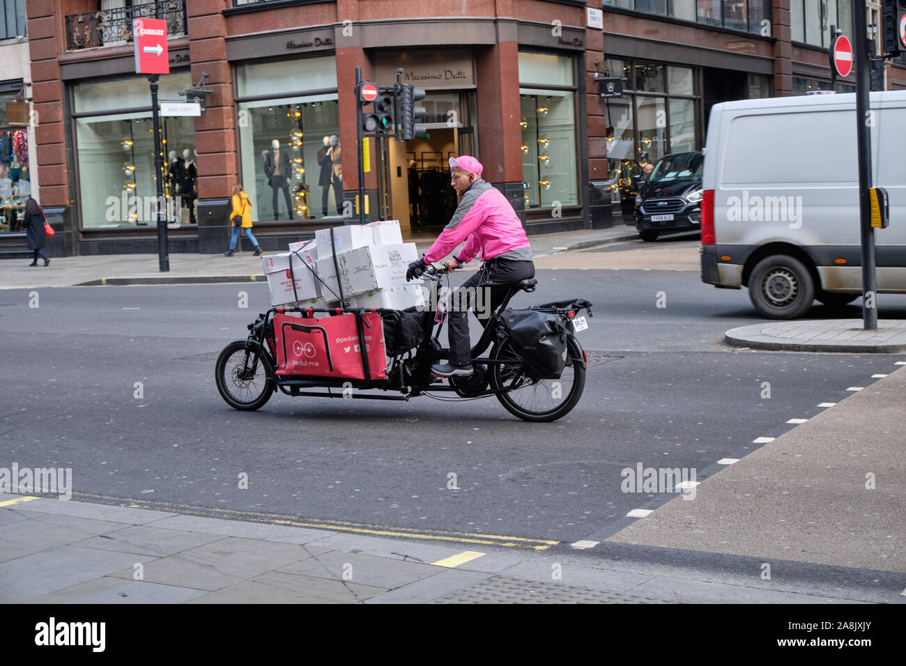 Pedal Me cargo bike delivery service, loaded with multiple boxes riding on Regent Street, London, UK. Stock Photo