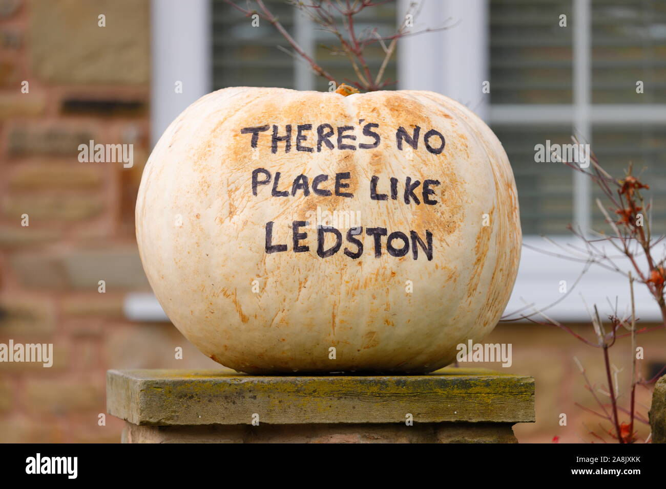 A pumkin on display in the village of Ledston which reads 'There's No Place Like Ledston' Stock Photo