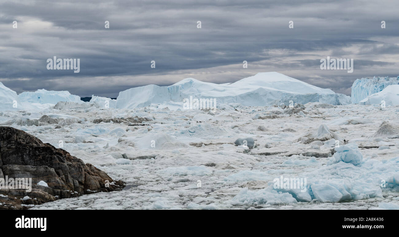 Icebergs from melting glacier in icefjord - Global Warming and Climate Change Icefjord in Ilulissat, Greenland. Aerial drone photo of arctic nature ice landscape. Unesco World Heritage Site. Stock Photo