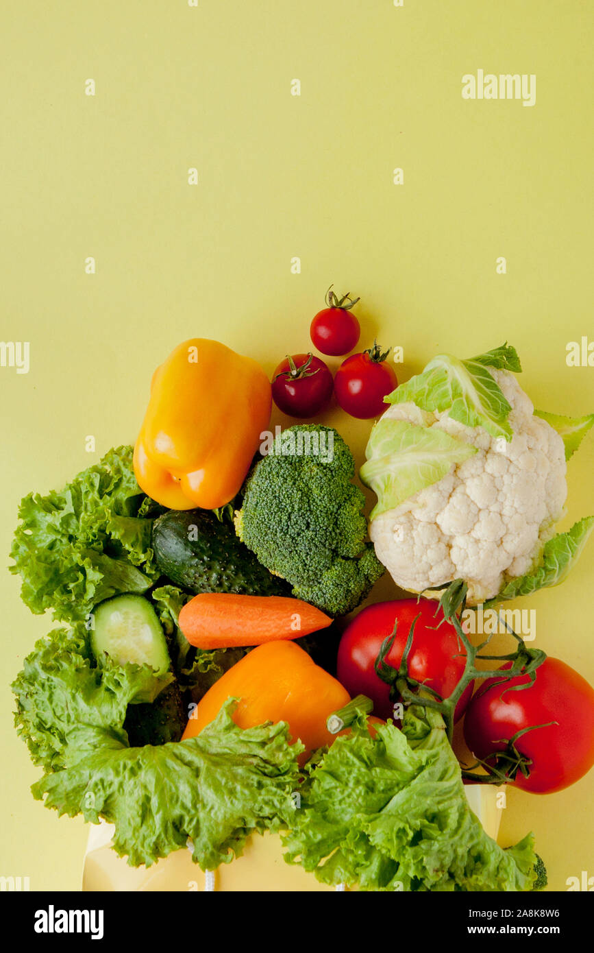 Organic vegetables broccoli cucumbers bell peppers apples in brown