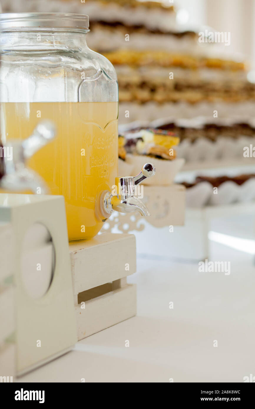 Glass jars of lemonade on wedding candy bar. Catering. Drinks on wedding party. Stock Photo