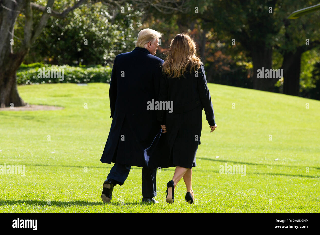 Washington DC, USA. 09th Nov, 2019. US President Donald J. Trump (L) and First Lady Melania Trump (R) walk aross the South Lawn of the White House to depart by Marine One in Washington, DC, USA, 09 November 2019. The President and First Lady will attend a National Collegiate Athletic Association (NCAA) football game between Alabama and Louisiana State University in Tuscaloosa, Alabama; then they will stay in New York City through Veterans Day. Credit: MediaPunch Inc/Alamy Live News Stock Photo