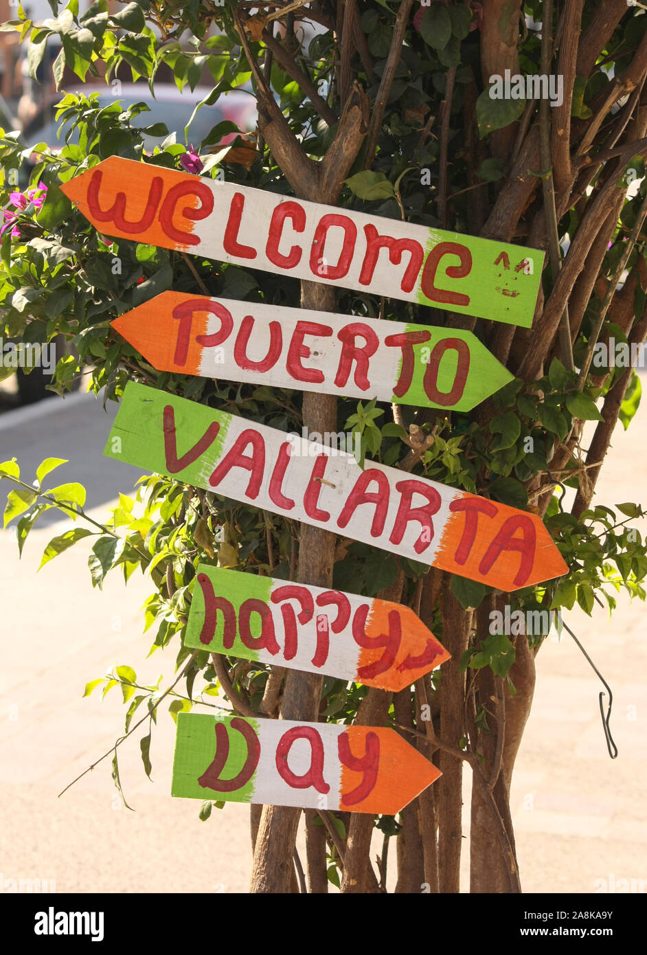 Patriotic colorful sign welcoming visitors to downtown Puerto Vallarta and encouraging everyone to have a Happy Day. Stock Photo