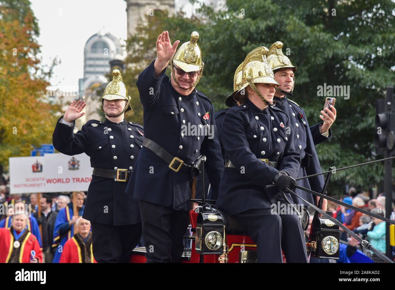 Members of the London Fire Brigade in old uniforms taking part during The Lord Mayor's Show in London.The traditional yearly procession brings together over 6,500 people, 120 horses and over 60 decorated floats in a major spectacle that dates back to the 13th century. It's 3 miles long and travels from Mansion House to the Royal Courts of Justice where the Lord Mayor takes an oath of allegiance to the sovereign before the Lord Chief Justice. Stock Photo