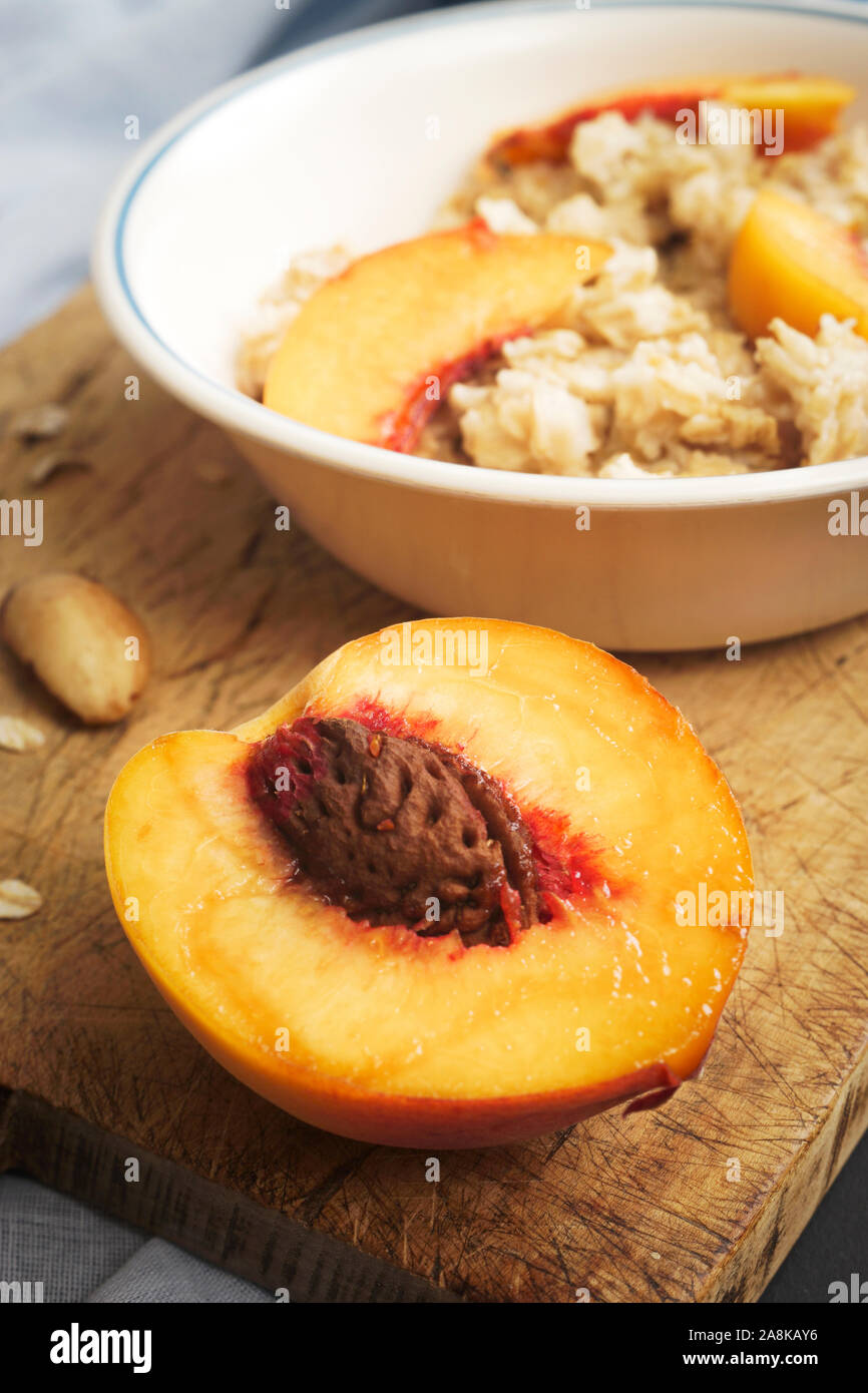 Healthy vegetarian breakfast dish of oatmeal and peaches Stock Photo Alamy