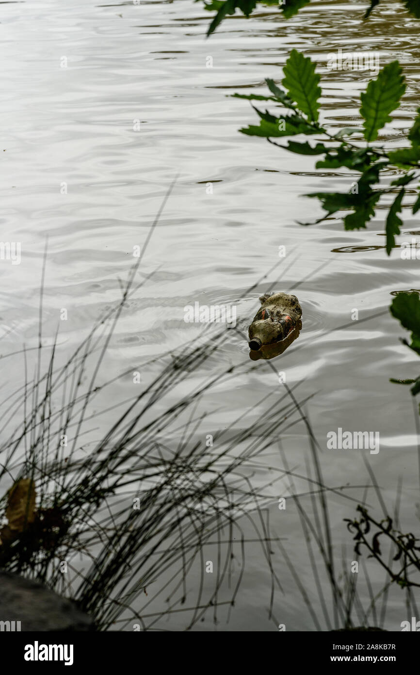 Empty plastic softdrink bottle floating in the river Stock Photo