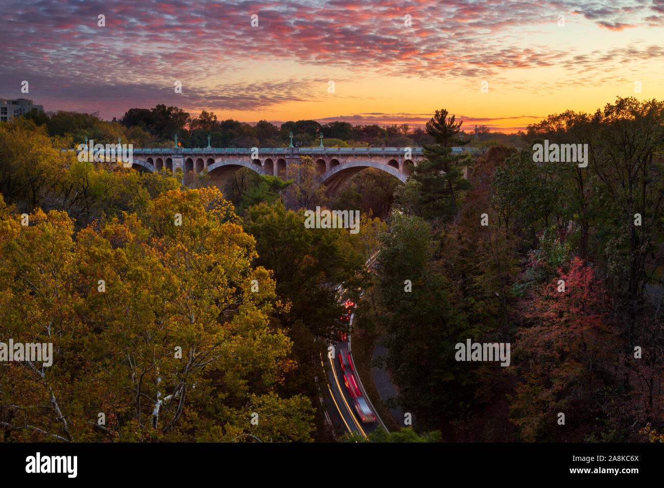 View of the William Howard Taft Bridge and cars in Rock Creek Park in Northwest Washington, DC at sunset in fall Stock Photo