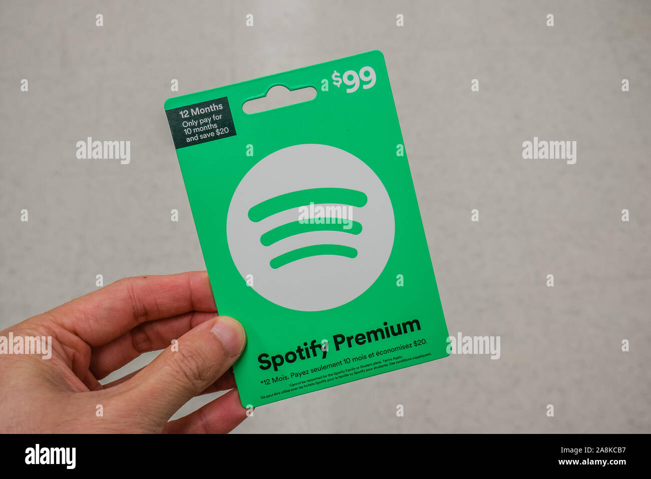 Spotify Pink Gift Card of Premium Subscription in a Hand at Store