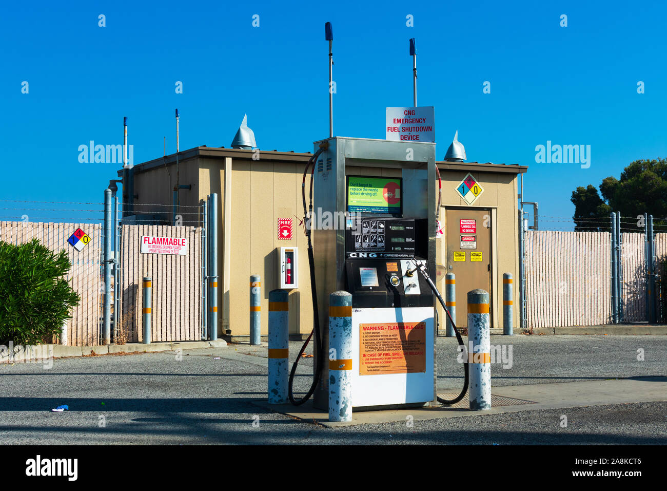 CNG, compressed natural gas, fueling public self service station for refueling natural gas vehicles. Flammable warning. Bollards secure the station fr Stock Photo