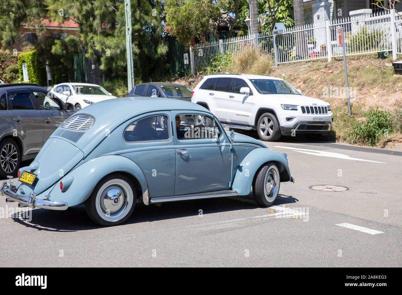 Classic Volkswagen beetle car in light blue driving on a Sydney road,Australia Stock Photo