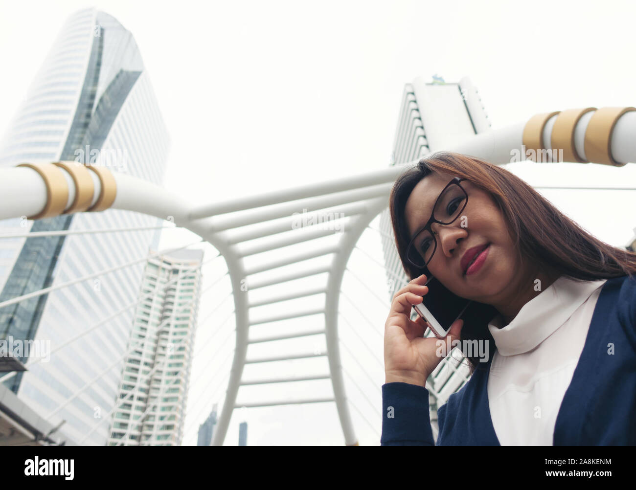 businesswoman walking outdoor and talking on mobile phone Stock Photo