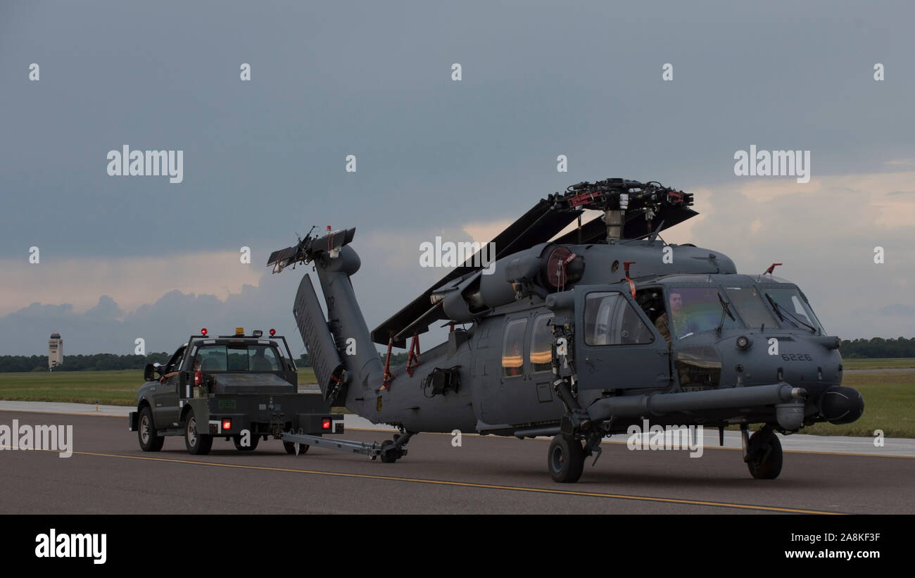 An HH-60 Pave Hawk Helicopter assigned to the 305th Rescue Squadron, Davis-Monthan Air Force Base, Ariz., is towed on the flightline at MacDill Air Force Base, Fla., Nov. 5, 2019. The Pave Hawk helicopters and support equipment were delivered to MacDill for an upcoming exercise. (U.S. Air Force photo by Airman 1st Class Ryan C. Grossklag) Stock Photo