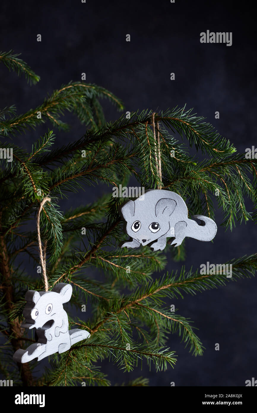 Christmas tree decorated with wooden toys. Two rats are gray and white